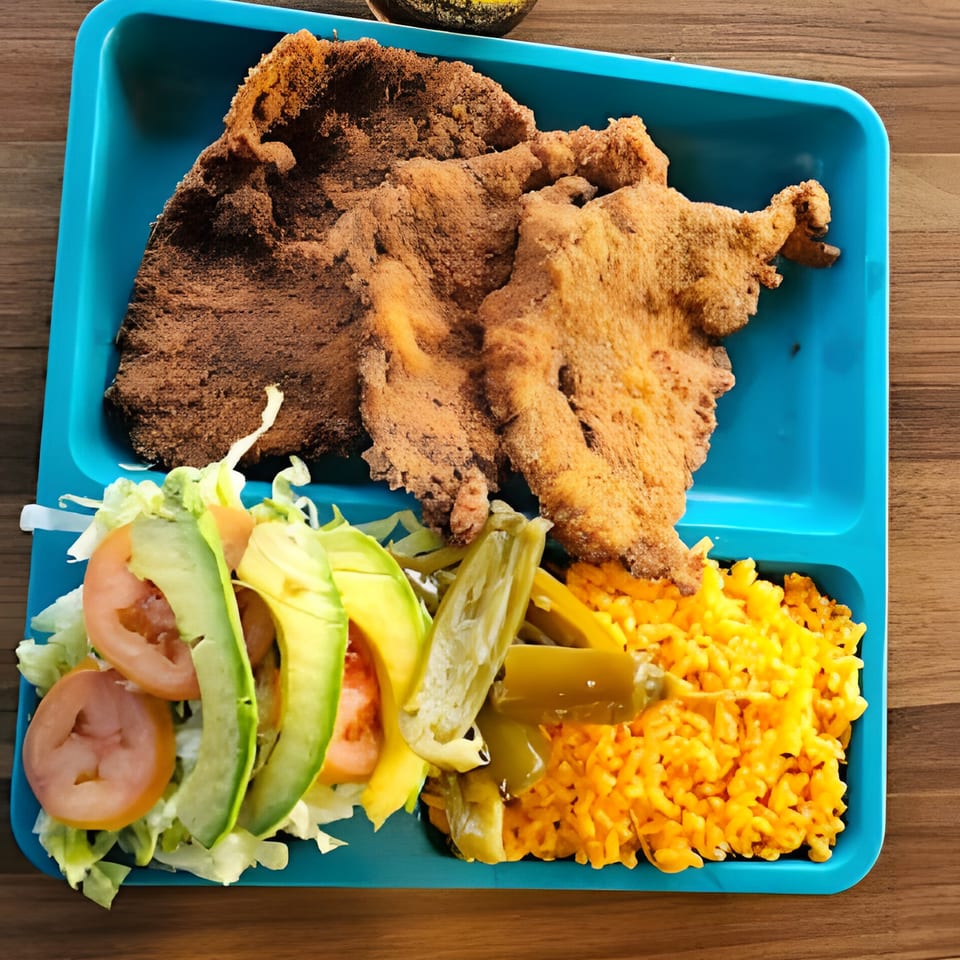 Mexican milanesa with rice, salad, and pickled peppers on a blue tray.